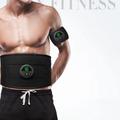 Man wearing EMS muscle stimulator belt and arm band